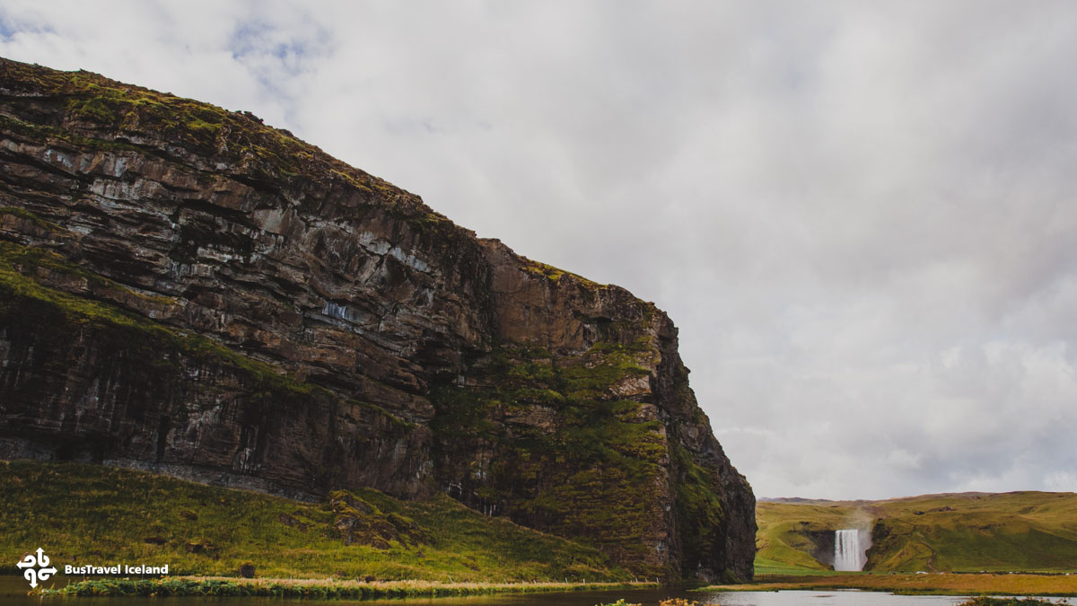 The dramatic landscape of Skogafoss waterfall