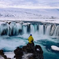 Adventurous man at Godafoss, Iceland in winter