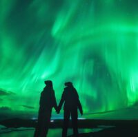 Northern lights over couple in love in Iceland