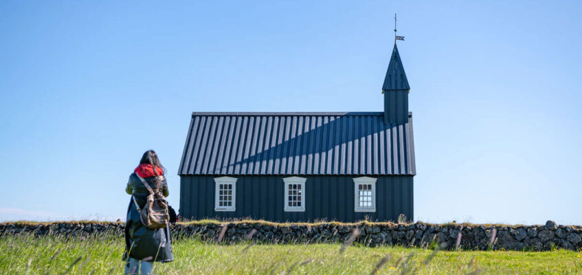 A woman walking towards Budir black church