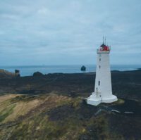 Reykjanesviti Lighthouse in a drone shot backdropped by coastal view