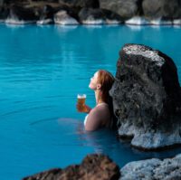 A guest is relaxing with a beer in hand at Myvatn Nature Bath