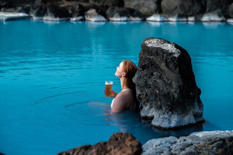 A guest is relaxing with a beer in hand at Myvatn Nature Bath