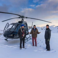 People standing near a helicopter in Icelandic mountains