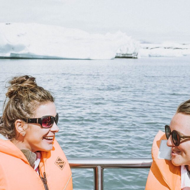 Women talking and smiling on a boat tour at the Glacier Lagoon