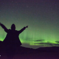 A person happy to see the Northern Lights