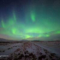 Northern Lights over snowy landscape