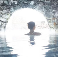 A woman walking under arch at the Blue Lagoon