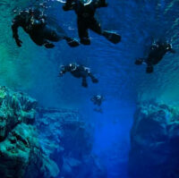 Underwater view on people snorkeling Silfra