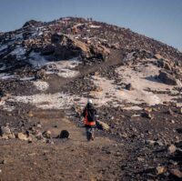 A group of hikers walking towards the newest eruption site