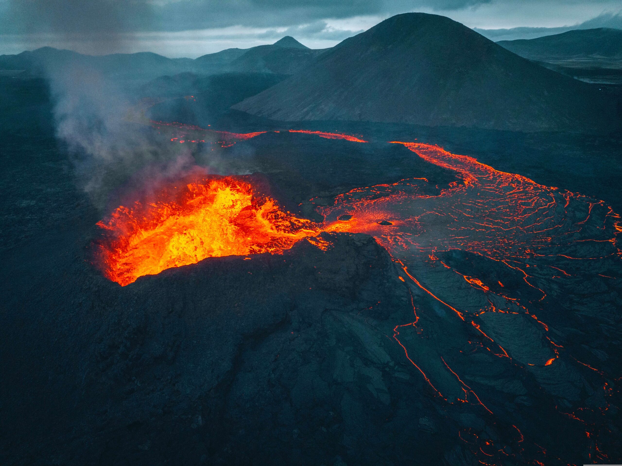 A drone shot of hot magma flowing out of a volcanic crater in Reykjanes in 2021