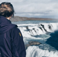 A visitor gazing at Gullfoss waterfall in golden circle