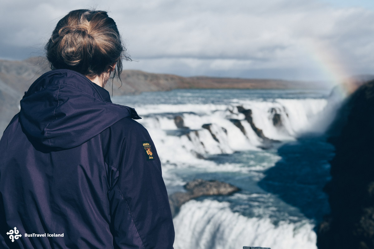 A visitor gazing at Gullfoss waterfall in golden circle