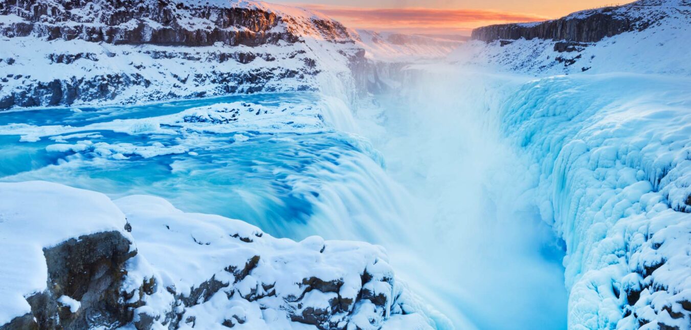 The Gullfoss Falls in Iceland in winter when the falls are partially frozen. Photographed at sunset.