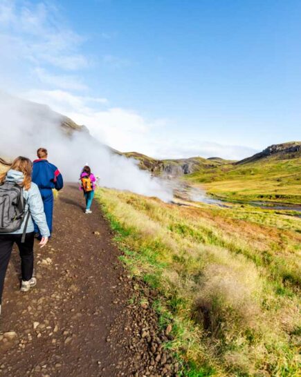 Reykjadalur Hot Springs road trail with steam fumarole vent during autumn day in golden circle