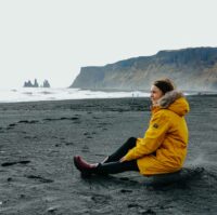 Sitting on black sand beach from Vik i Myrdal in South Iceland