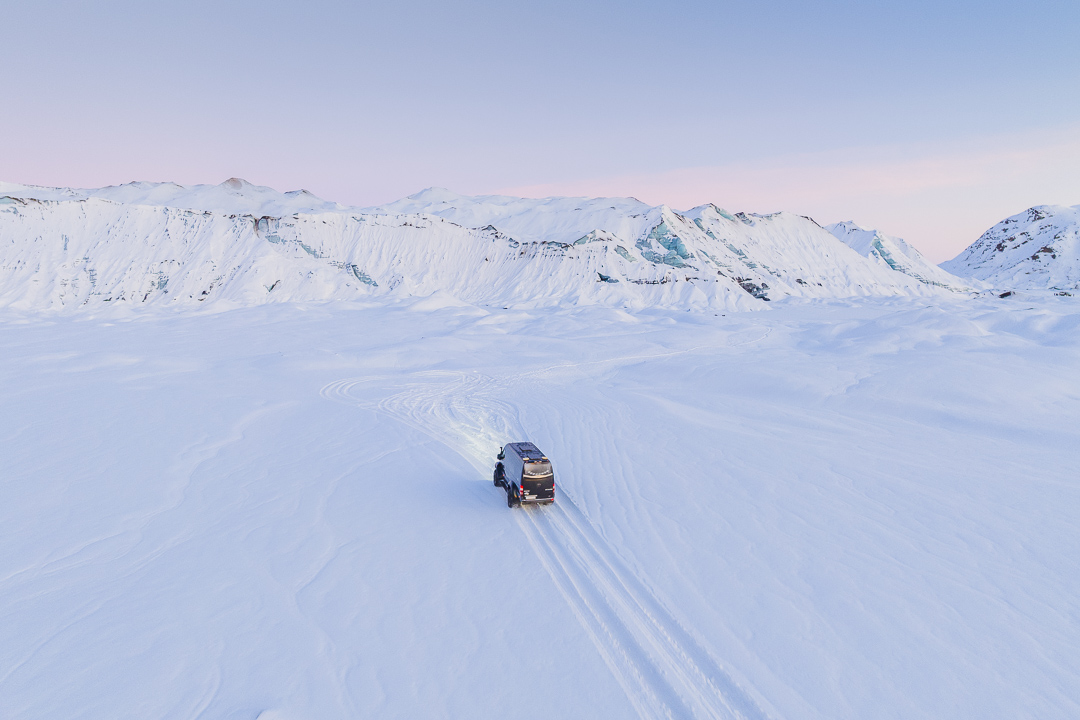 Gravel Travel Katla Ice Cave December 2024-7 A super jeep is driving on the snowy land to explore an ice cave.