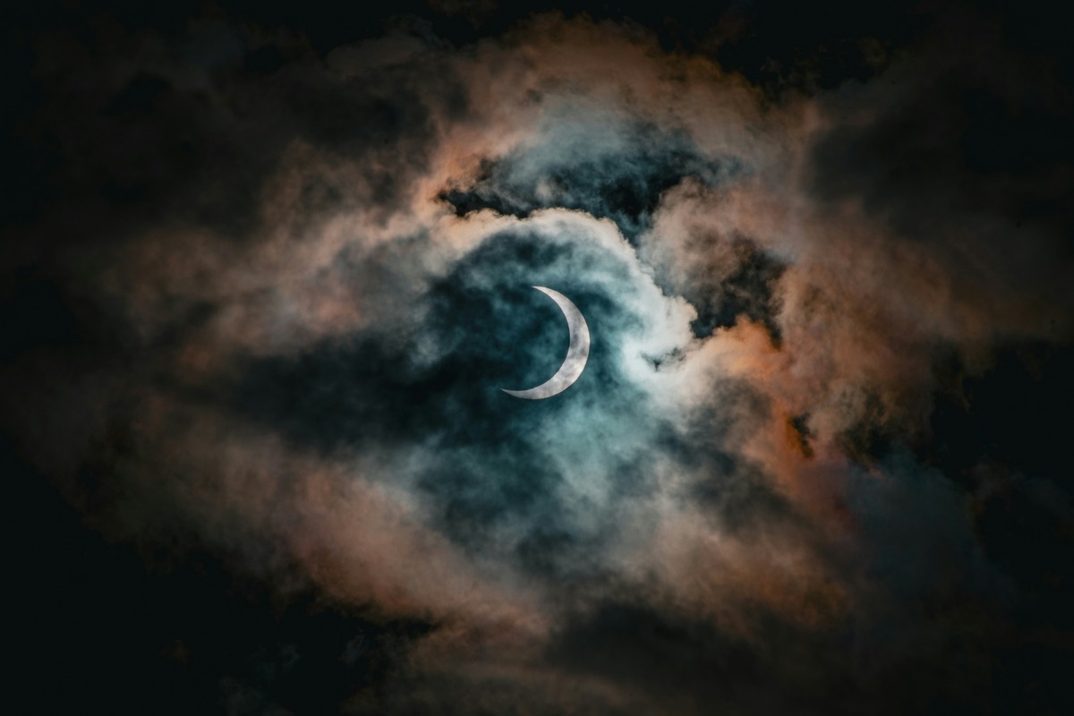 Solar eclipse behind clouds