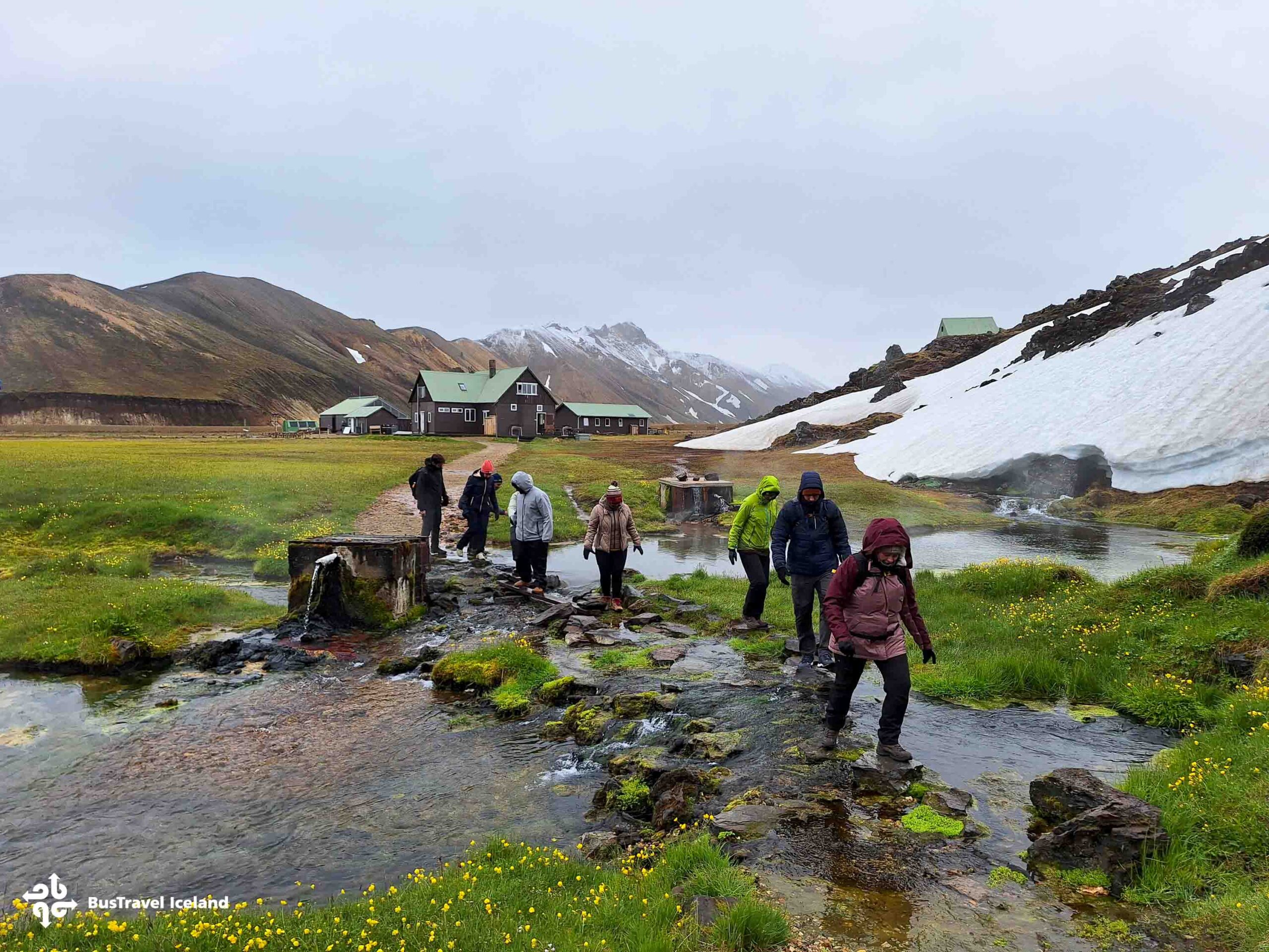 Group of hikers walking toward the hot springs in Landmannalaugar, Iceland.