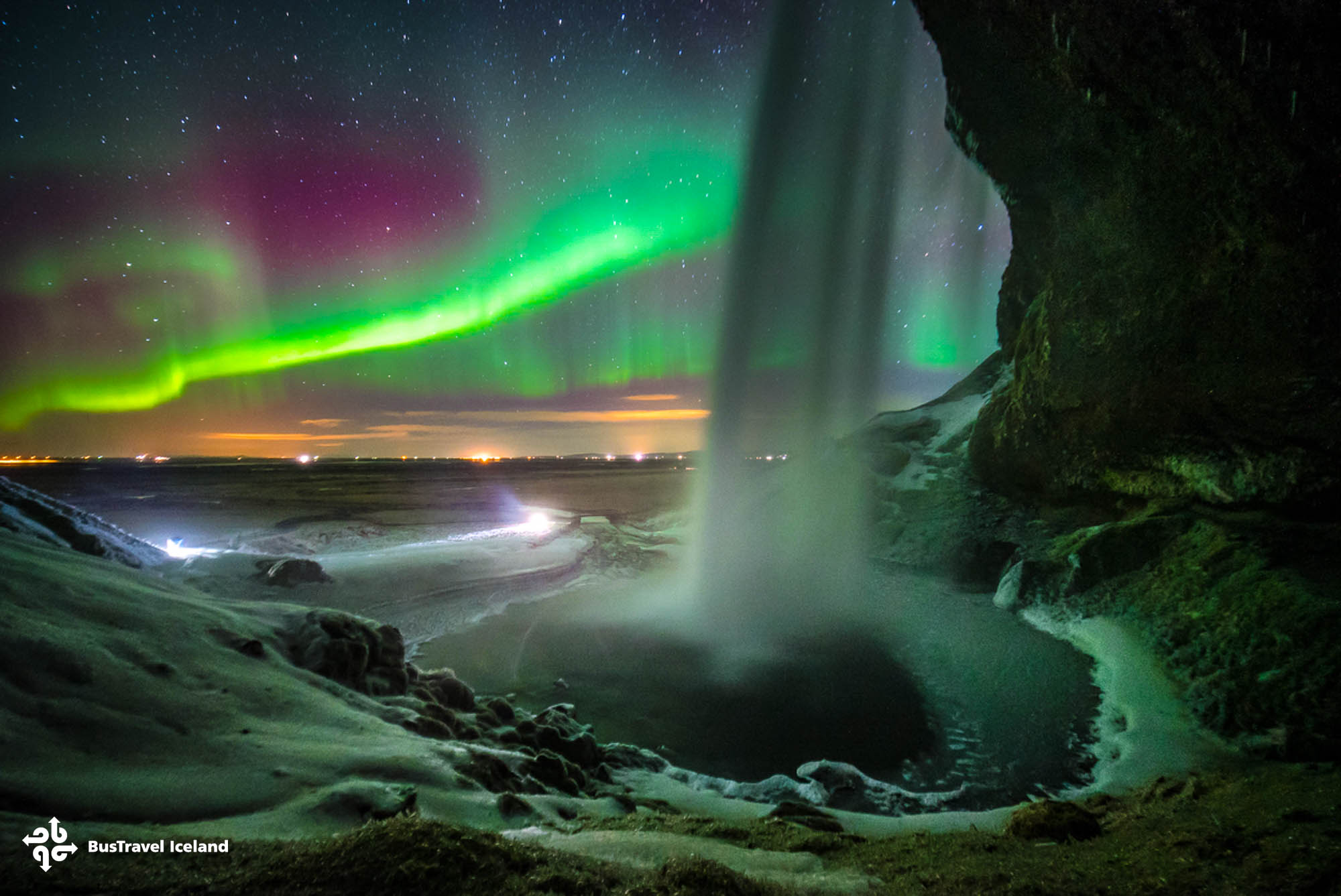Northern lights dancing over Seljalandsfoss waterfall south iceland Northern lights dancing over Seljalandsfoss waterfall south iceland