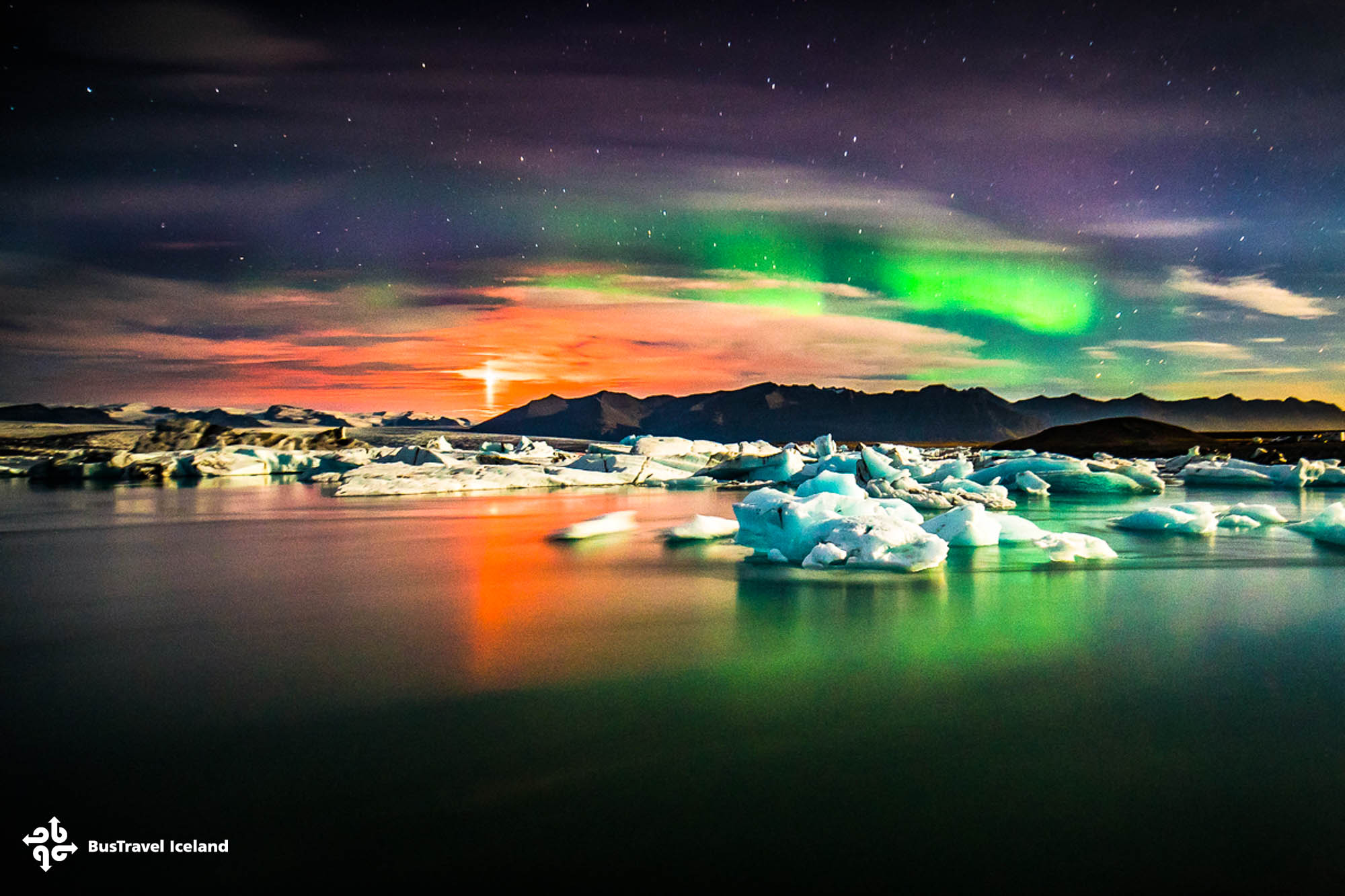 Jokulsarlon glacier lagoon with aurora dancing above