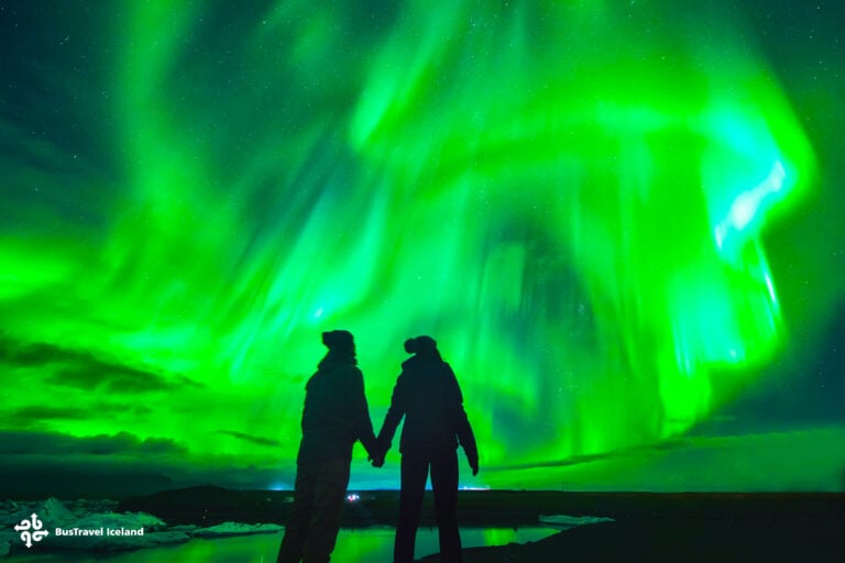 Northern lights over couple in love in Iceland