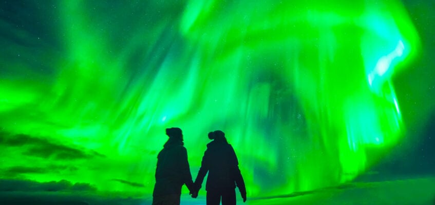 Northern lights over couple in love in Iceland